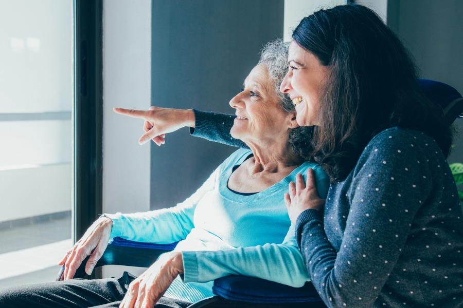 woman with mother with dementia sharing a smile 