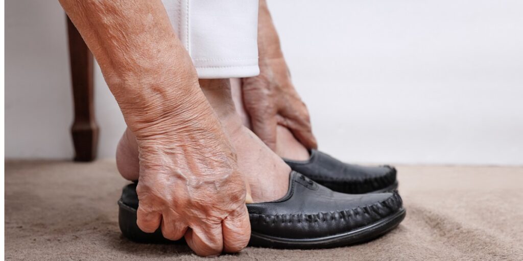 senior-putting-on-laceless-shoes