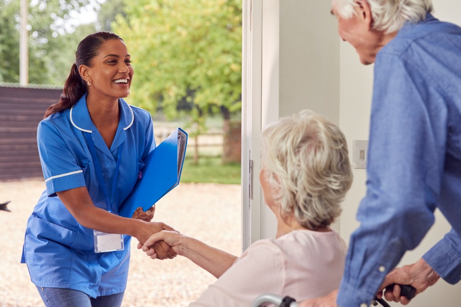 senior-couple-greeting-caregiver